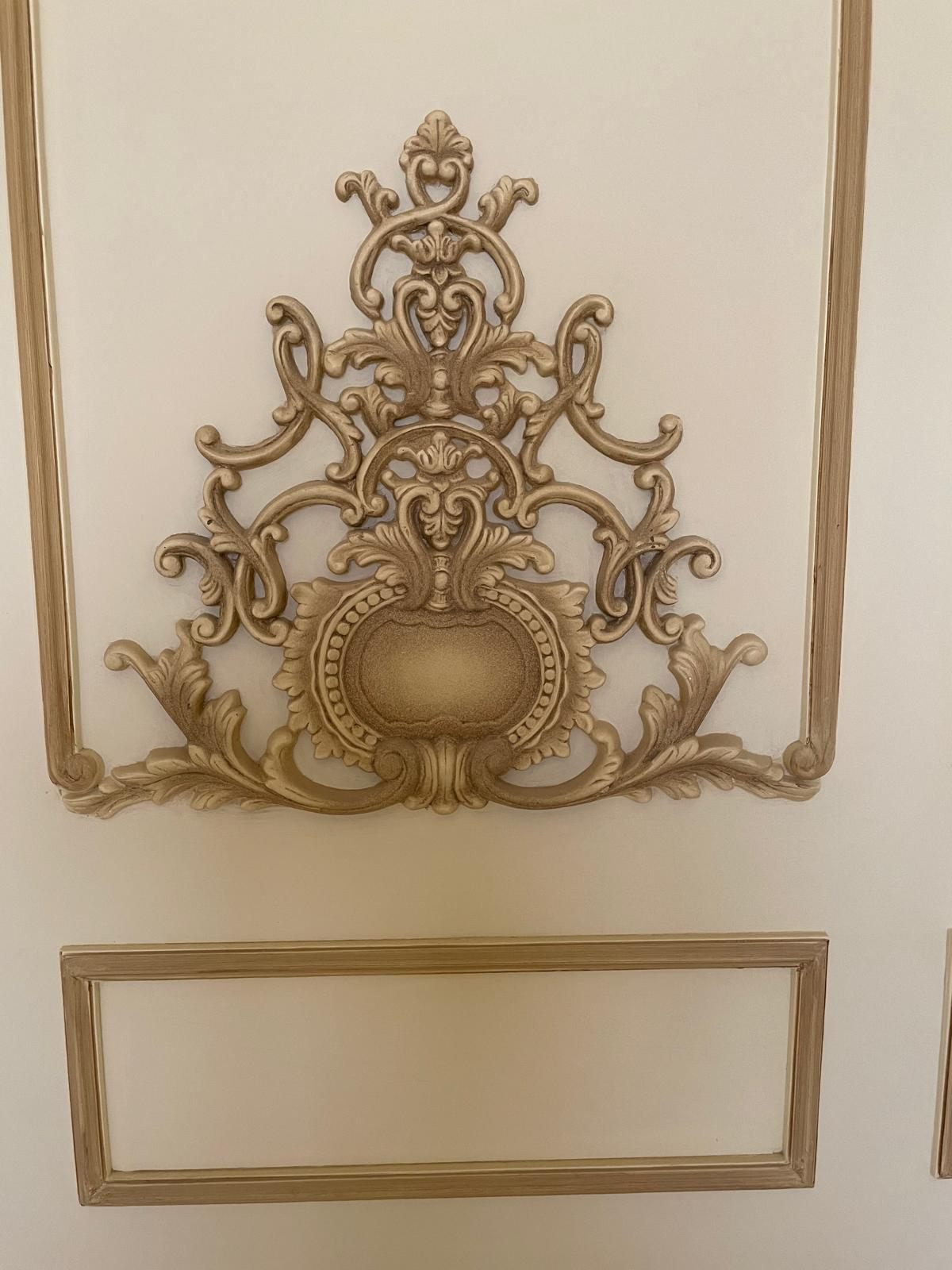 Gilded ornamental wall pediment detail