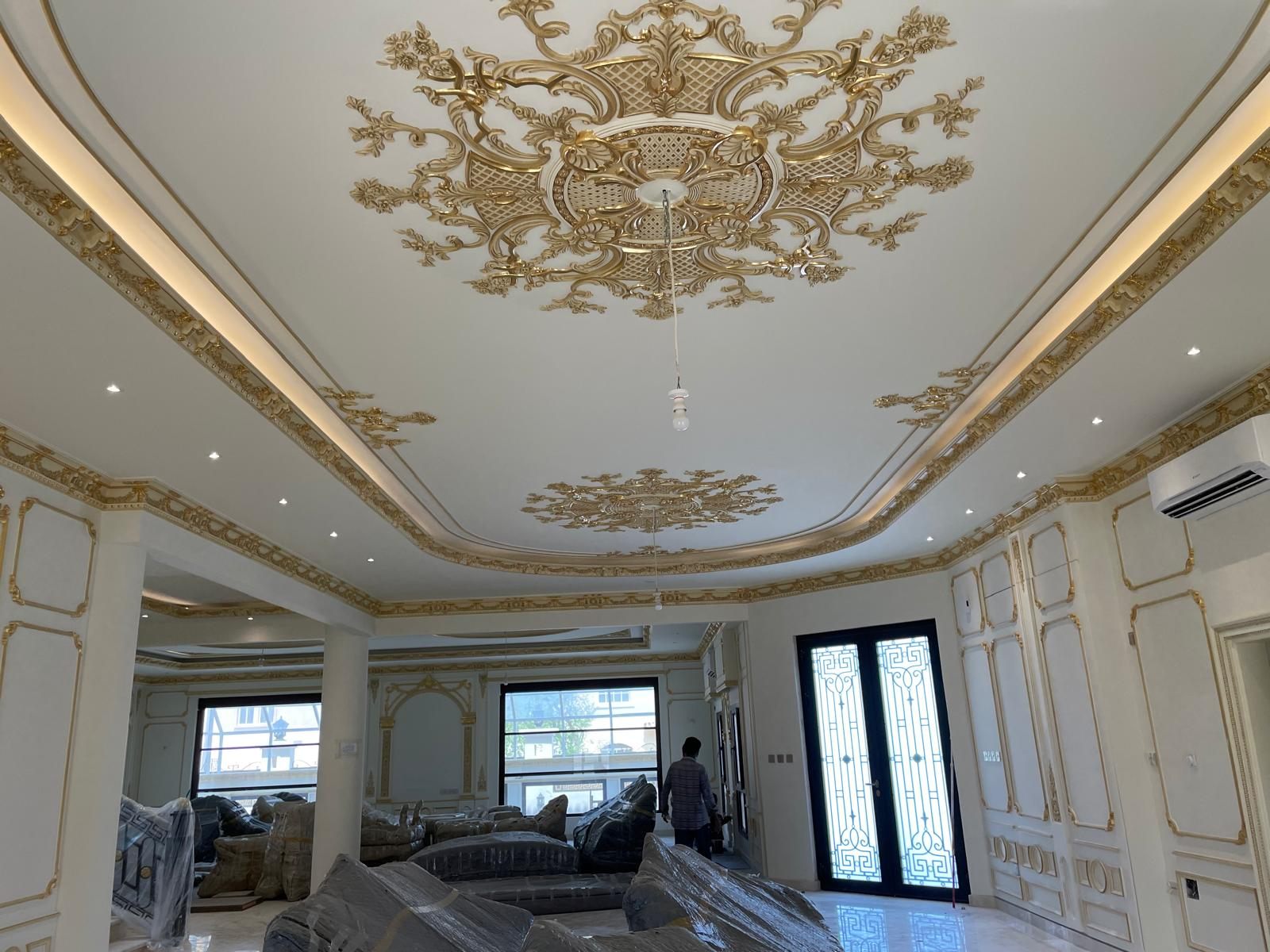 ArtCastle craftsmen installing a gold-leaf gypsum ceiling in a Doha majlis